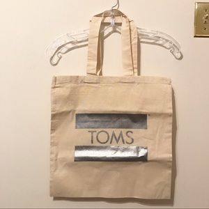 TOMS tote and sticker.